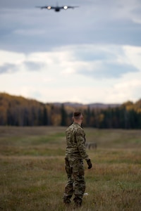 U.S. Air Force Staff Sgt. Douglas Moye, a 773d Logistics Readiness Squadron combat mobility technician supervisor, observes an Alaska Air National Guard C-130J Super Hercules while it conducts air drop qualification training at Joint Base Elmendorf-Richardson, Alaska, Oct. 3, 2018. When air drop training occurs, combat mobility technicians are also called upon to operate as malfunction officers at the drop zone.