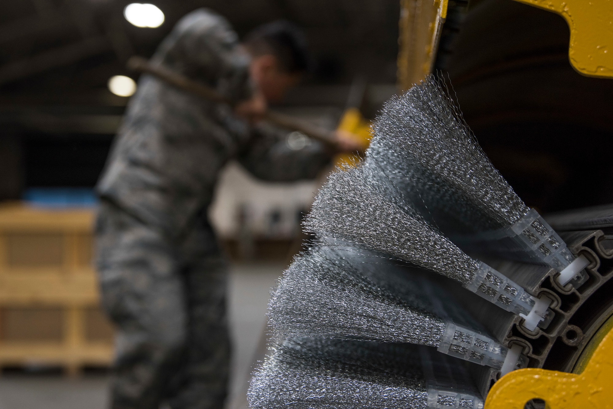 U.S. Air Force Senior Airman Christian Castaneda-Magana, 773d Civil Engineer Squadron water and fuels systems maintenance operator, pulls bristles onto a broom at Joint Base Elmendorf-Richardson, Alaska, Oct. 4, 2018. The 773d CES snow barn personnel prepare for the coming winter by reviewing and installing new equipment, attending safety briefings and participating in the Snow and Ice Parade.