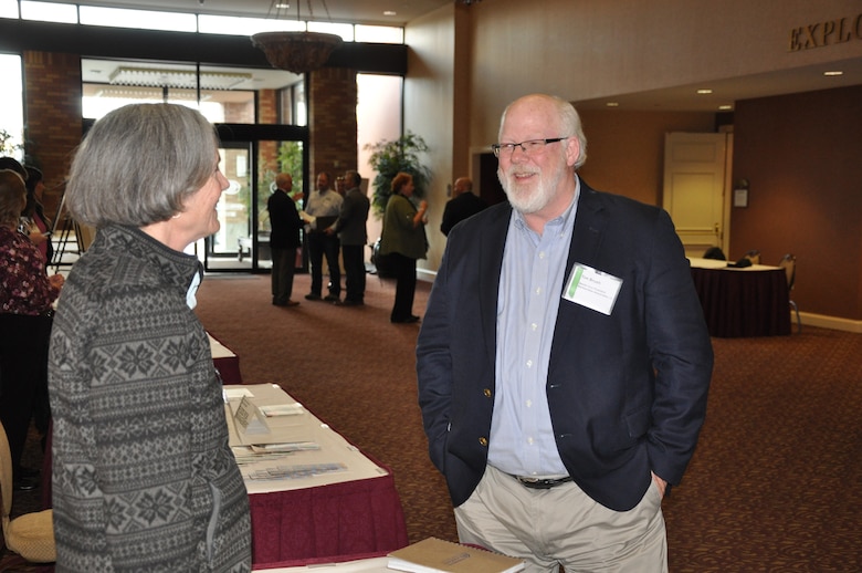Tim Bruch, senior vice president for Normandeau Associates, Inc., discusses fisheries research work with Ann Setter, Walla Walla District's Operations Division lead fishery biologist, during a break at the Corps’ ‘Industry Day,’ held Wednesday, Oct. 10, at the Marcus Whitman Hotel and Conference Center in Walla Walla, Washington.