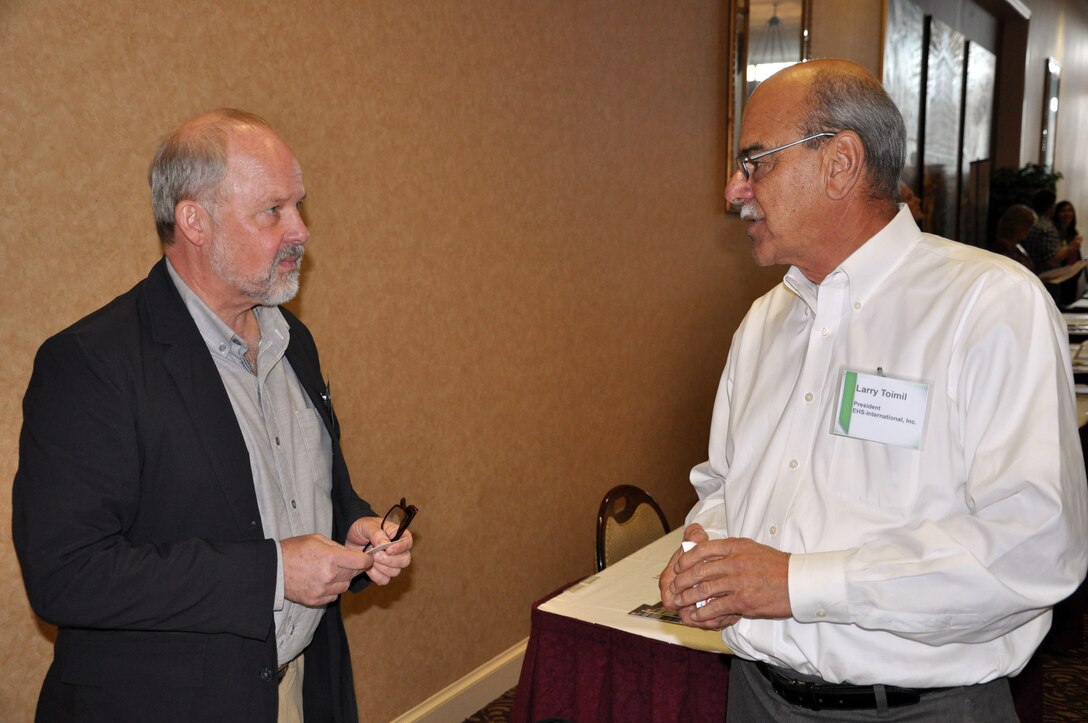 Ezra Abraham, general engineering section chief at the U.S. Army Corps of Engineers' Walla Walla District, talks with Larry Toilmil, president of EHS-International Inc., about how to do business with the Corps during ‘Industry Day’ on Wednesday, Oct. 10, at the Marcus Whitman Hotel and Conference Center in Walla Walla, Washington.