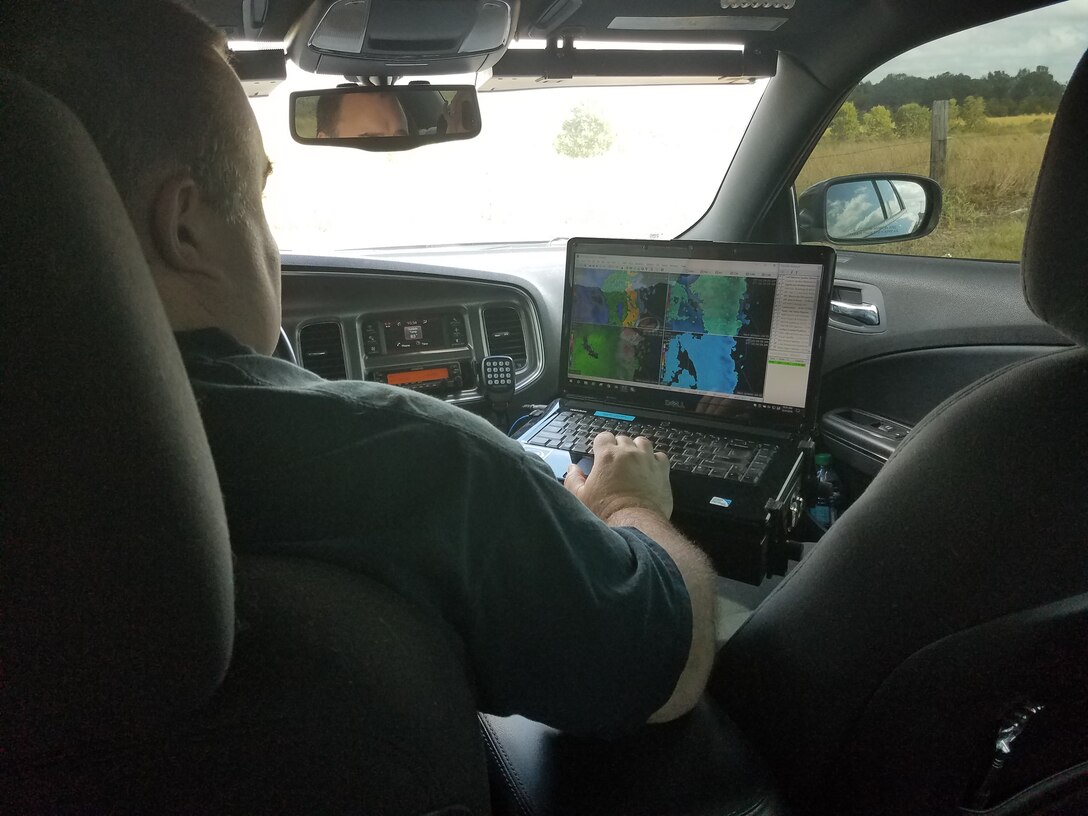 Man in car looking at dash screen