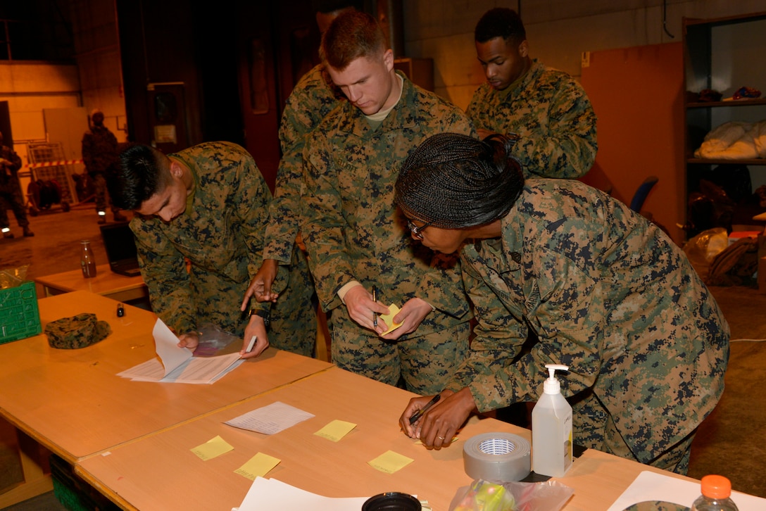 Marines verify rosters to ensure approximately 300 Marines from units all across II Marine Expeditionary Force are accounted for after their arrival at Vaernes Air Station, Norway, from Camp Lejeune, N.C., on Oct. 3, 2018, in order to participate in Exercise Trident Juncture 2018. Trident Juncture 18 enhances the U.S. and NATO Allies' abilities to work together collectively to conduct military operations under challenging conditions. (U.S. Marine Corps photo by GySgt. Rebekka S. Heite)