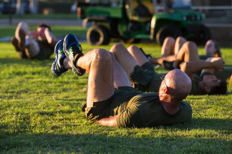 Col. David A. Suggs, the commanding officer of Marine Corps Air Station (MCAS) Yuma, performs “bicycle kicks” during High Intensity Tactical Training (HITT) on the Lawn, at the parade deck on Marine Corps Air Station Yuma, Ariz., Sept. 28, 2018. HITT on the Lawn is a physical training event that is open to anyone with base access and provides them with a physical training opportunity. (U.S. Marine Corps photo taken by Cpl. Isaac D. Martinez)