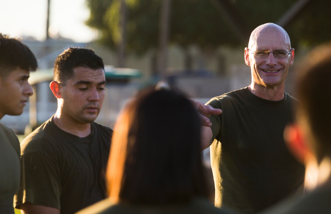 Col. David A. Suggs, the commanding officer of Marine Corps Air Station (MCAS) Yuma, speaks to a group of Marines assigned to Headquarters and Headquarters Squadron during High Intensity Tactical Training (HITT) on the Lawn, at the parade deck on Marine Corps Air Station Yuma, Ariz., Sept. 28, 2018. HITT on the Lawn is a physical training event that is open to anyone with base access and provides them with a physical training opportunity. (U.S. Marine Corps photo taken by Cpl. Isaac D. Martinez)