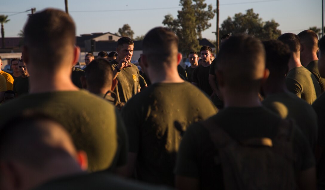 Lt. Col. James C. Paxton III, the commanding officer of Headquarters and Headquarters Squadron (H&HS), speaks to a group of Marines assigned to H&HS about the importance of physical training, just after the completion of High Intensity Tactical Training (HITT) on the Lawn, at the parade deck on Marine Corps Air Station Yuma, Ariz., Sept. 28, 2018. HITT on the Lawn is a physical training event that is open to anyone with base access and provides them with a physical training opportunity. (U.S. Marine Corps photo taken by Cpl. Isaac D. Martinez)