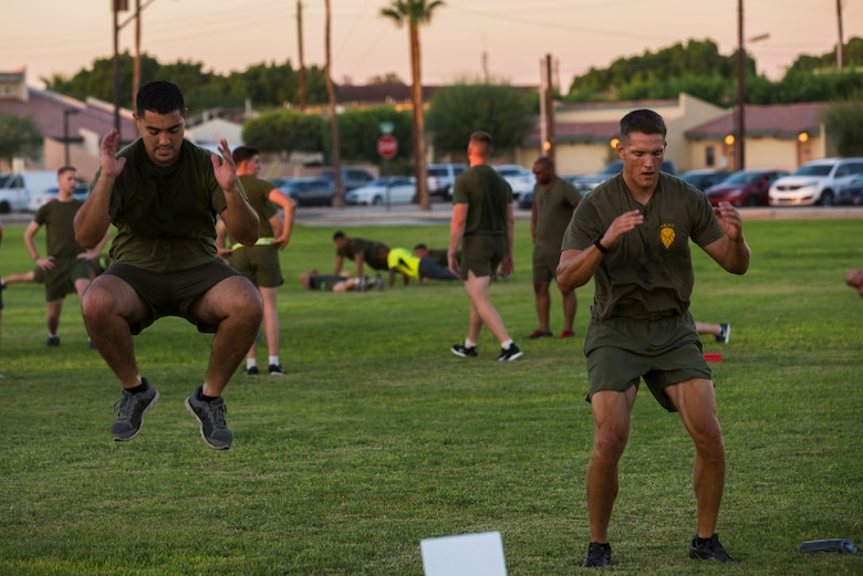 Lt. Col. James C. Paxton III, the commanding officer of Headquarters and Headquarters Squadron (H&HS), conducts a “squat jump” exercise beside another Marine during High Intensity Tactical Training (HITT) on the Lawn, at the parade deck on Marine Corps Air Station Yuma, Ariz., Sept. 28, 2018. HITT on the Lawn is a physical training event that is open to anyone with base access and provides them with a physical training opportunity. (U.S. Marine Corps photo taken by Cpl. Isaac D. Martinez)