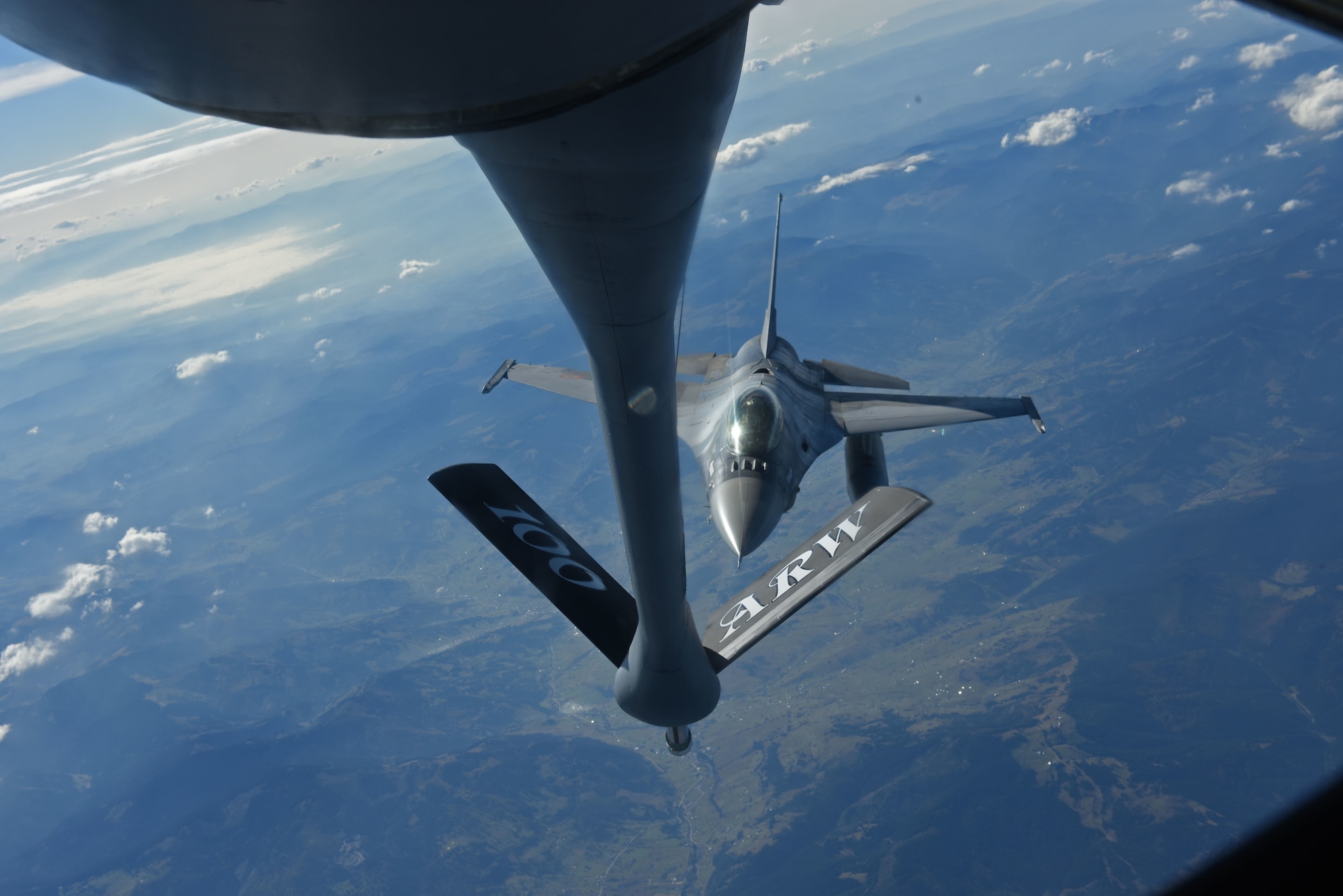 A Romanian air force F-16 Fighting Falcon flies behind a U.S. Air Force KC-135 Stratotanker from RAF Mildenhall, England, during Exercise Clear Sky over Romania, Oct. 10, 2018. The exercise is a joint and multinational exercise that involved approximately 950 personnel from nine nations. (U.S. Air Force photo by Senior Airman Luke Milano)