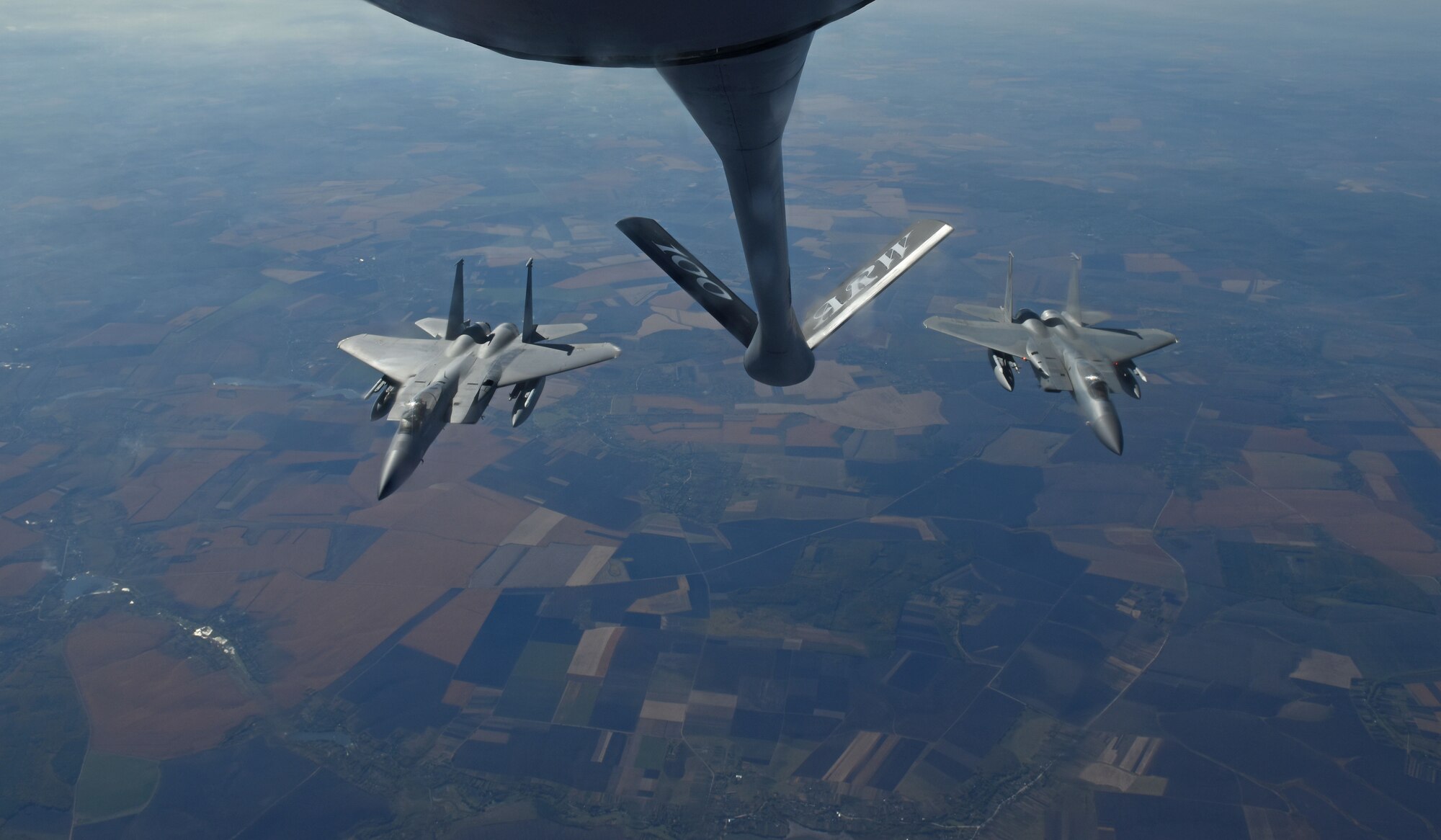 Two U.S. Air Force F-15C Eagles from the 144th Fighter Wing, Fresno Air National Guard Base, Calif., fly behind a U.S. Air Force KC-135 Stratotanker from RAF Mildenhall, England, after receiving fuel during Exercise Clear Sky over Romania, Oct. 10, 2018. The exercise is a joint and multinational exercise that involved approximately 950 personnel from nine nations. (U.S. Air Force photo by Senior Airman Luke Milano)