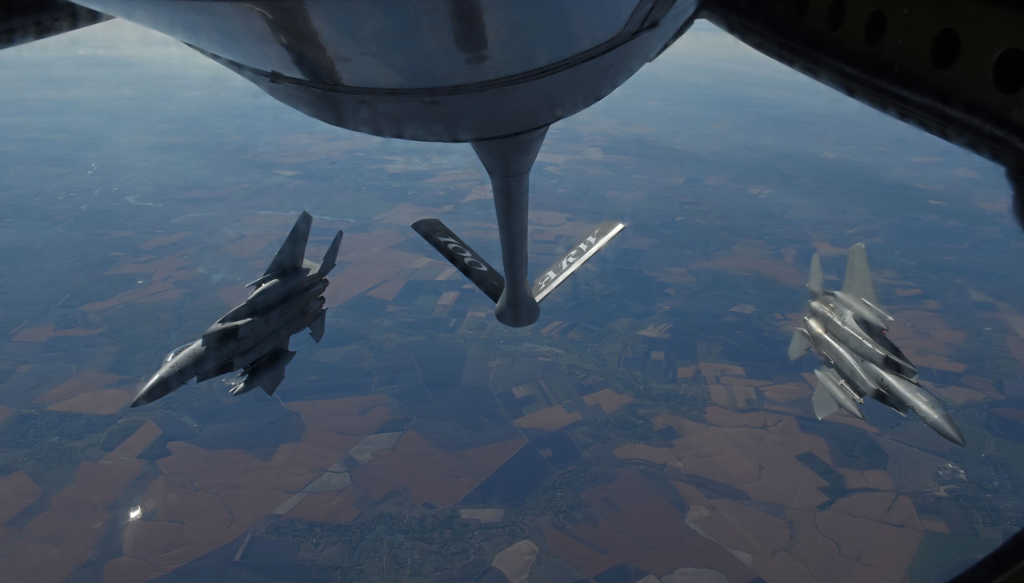 Two U.S. Air Force F-15C Eagles from the 144th Fighter Wing, Fresno Air National Guard Base, Calif., break away behind a KC-135 Stratotanker from RAF Mildenhall, England, after receiving fuel during Exercise Clear Sky over Romania, Oct. 10, 2018. The exercise is a joint and multinational exercise that involved approximately 950 personnel from nine nations. (U.S. Air Force photo by Senior Airman Luke Milano)