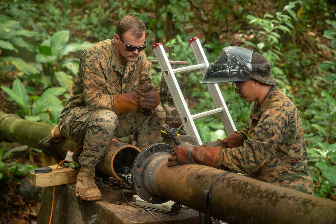 U.S. Marines assess the repair process on a broken water valve in Trujillo, Honduras, Sept. 22, 2018.