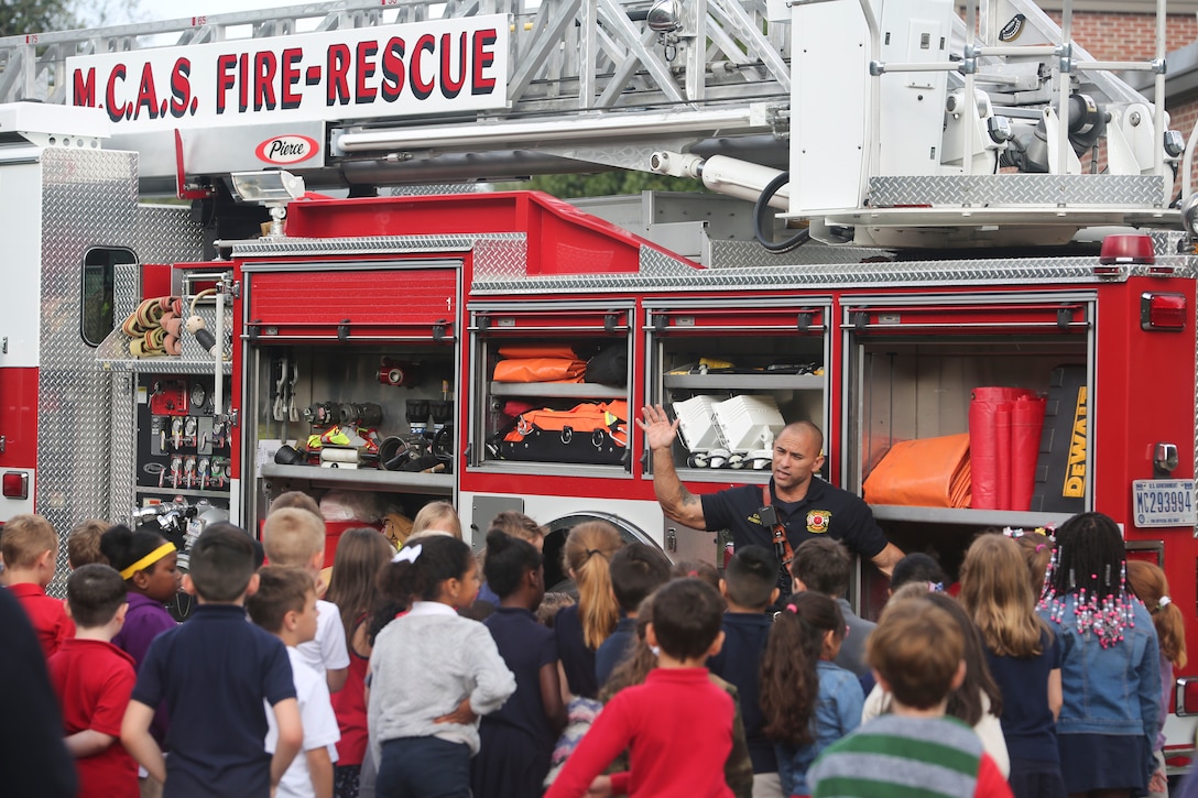Capt. Bobby Clark gives a demonstration of tools and equipment to students at Elliott Elementary on Laurel Bay Oct. 9. The demonstration was held to educate the students
about fire safety as well as fire prevention techniques in recognition of National Fire Prevention Week. Clark is a firefighter with MCAS Beaufort Fire.