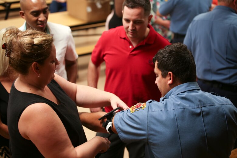 Teachers practice using a tourniquet on a paramedic at Bolden Elementary School on Laurel Bay, Oct. 9. The tourniquet is part of the Jacob Kit, a small trauma kit created by the Burton Fire District and named after a student who was wounded during a school shooting but died three days later due to blood loss.