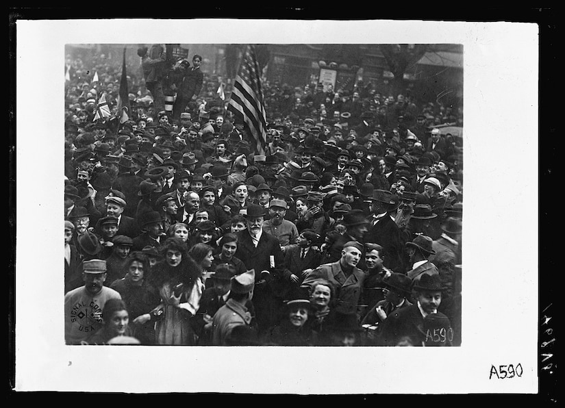 American Doughboys surrounded by French civilian celebrate the Armistice in Paris.
