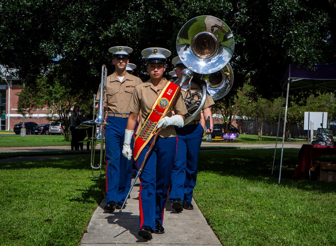U.S. Marine Corps band members with the Marine Forces Reserve Band march toward the stage during the Algiers Festival 2018 in Federal City, New Orleans, Oct. 6, 2018. The band performed to show their support towards the New Orleans community and kicked off the Algiers Festival 2018. (U.S. Marine Corps photo by Cpl, Andy O. Martinez)