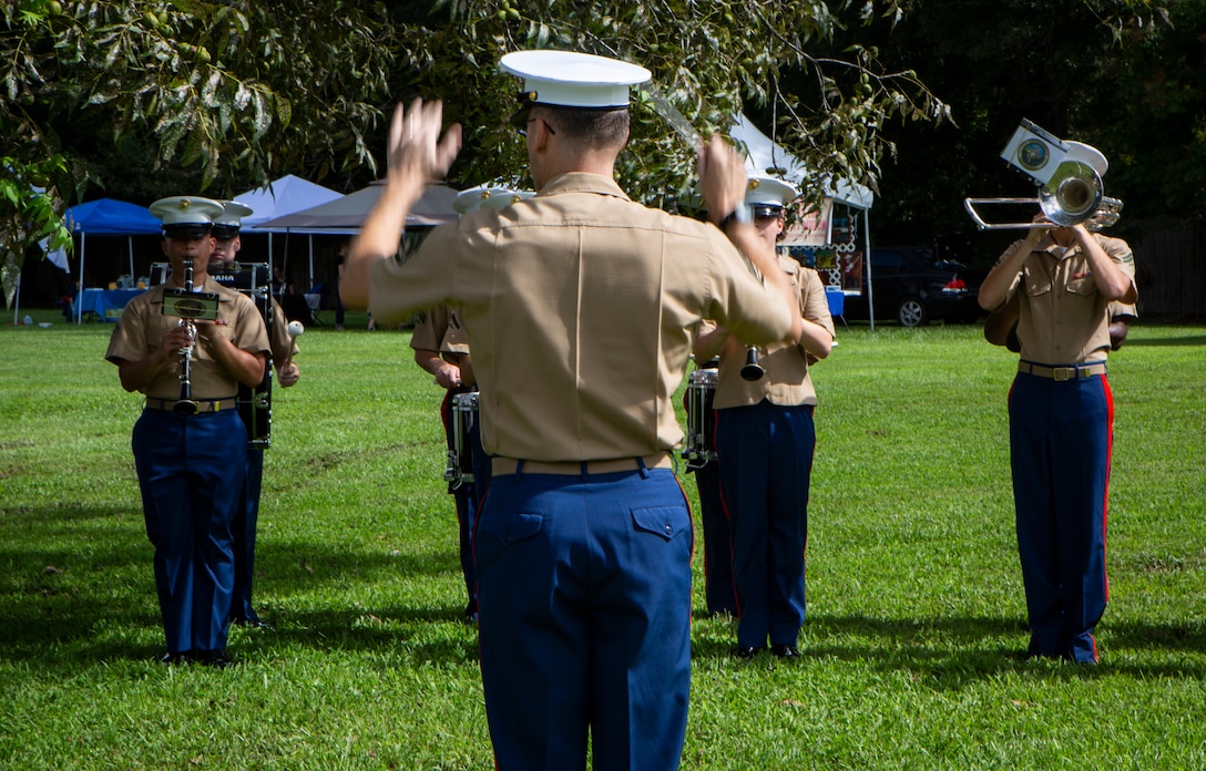 Staff Sgt. Marcus Bailey, enlisted conductor with the Marine Forces Reserve Band, directs the band during the Algiers Festival 2018 in Federal City, New Orleans, Oct. 6, 2018. The band performed to show their support towards the New Orleans community and kicked off the Algiers Festival 2018. (U.S. Marine Corps photo by Cpl, Andy O. Martinez)