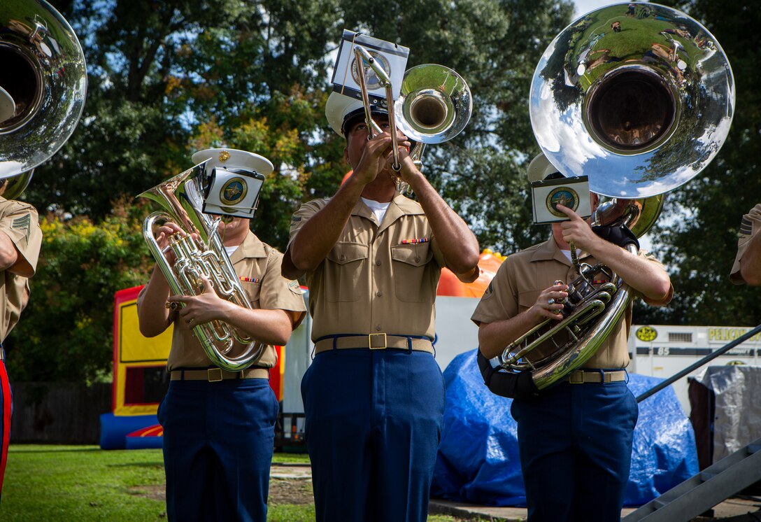 Lance Cpl. Brandon Carbonari, a trombone instrumentalist with the Marine Forces Reserve Band, performs during the Algiers Festival 2018 in Federal City, New Orleans, Oct. 6, 2018. The band performed to show their support towards the New Orleans community and kicked off the Algiers Festival 2018. (U.S. Marine Corps photo by Cpl, Andy O. Martinez)