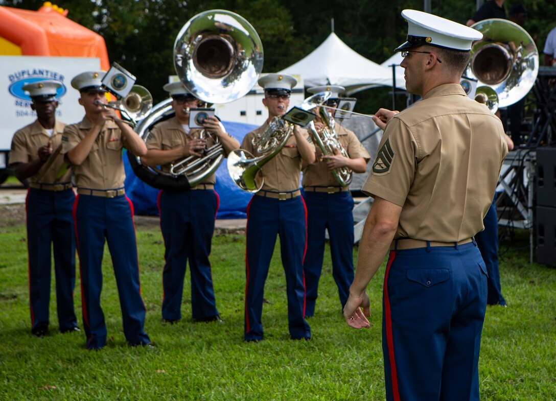 Staff Sgt. Marcus Bailey, enlisted conductor with the Marine Forces Reserve Band, directs the band during the Algiers Festival 2018 in Federal City, New Orleans, Oct. 6, 2018. The band performed to show their support towards the New Orleans community and kicked off the Algiers Festival 2018. (U.S. Marine Corps photo by Cpl, Andy O. Martinez)