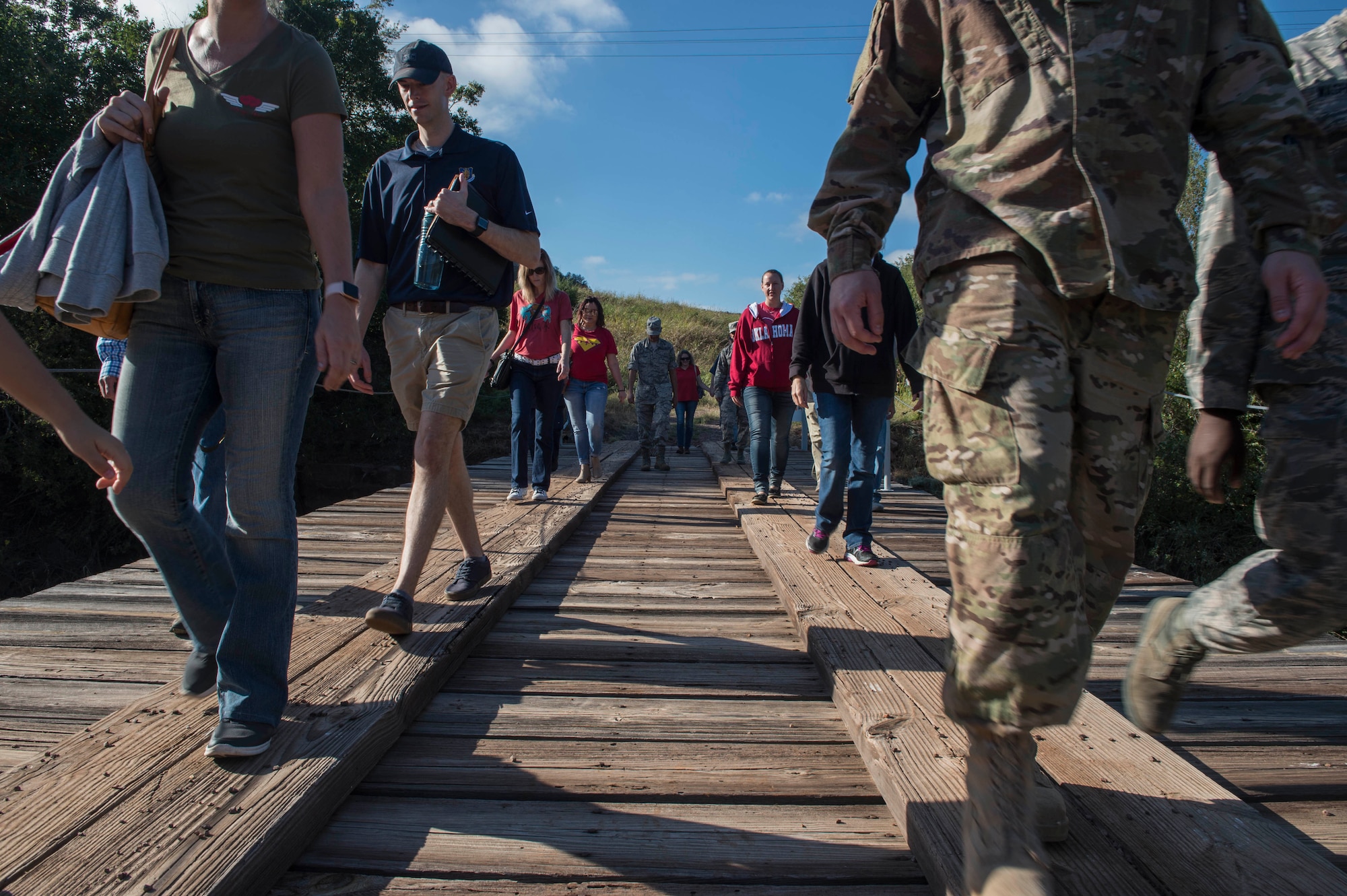 Members of the 97th Air Mobility Wing cross a bridge, during the Lake Altus-Lugert Dam tour, Oct. 5, 2018, in Lugert, Okla.