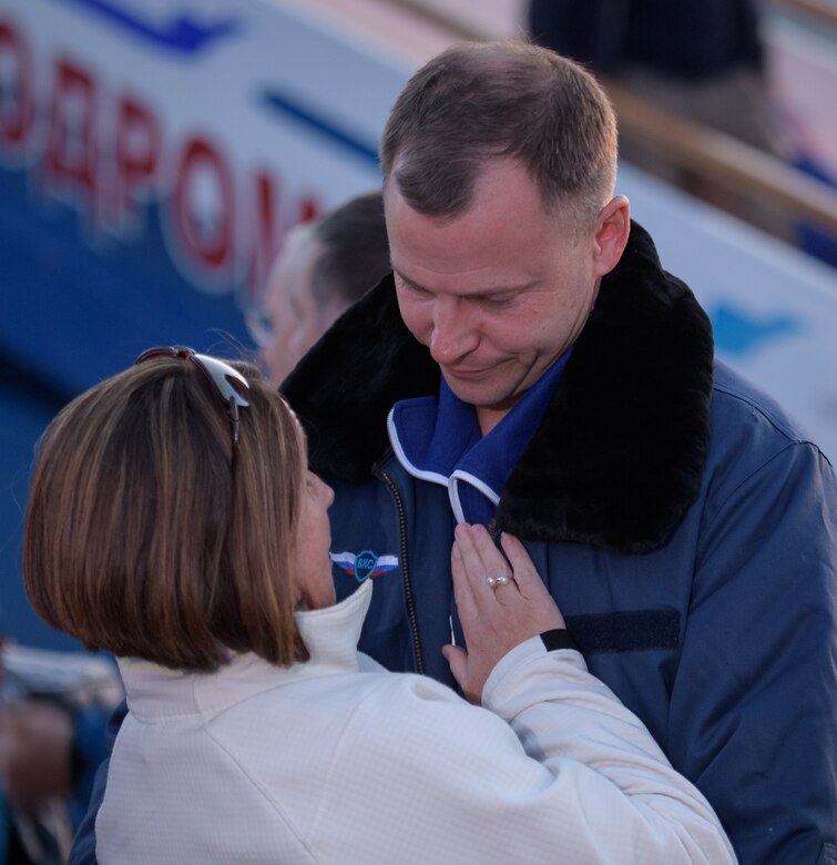 Air Force Col. Nick Hague of NASA embraces his wife, Air Force Lt. Col. Catie Hague, after landing at the Krayniy Airport in Baikonur, Kazakhstan.