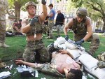 U.S. Air Force Pararescuemen, 304th Rescue Squadron Portland, Oregon, provide medical attention to Airman First Class James Pedrie, PJ Rodeo volunteer, for a simulated gunshot wound at the PJ Rodeo in San Antonio, Texas, Sept. 19, 2018. The PJ Rodeo provides comradery, networking opportunities, and serves as a source of additional training for competitors.