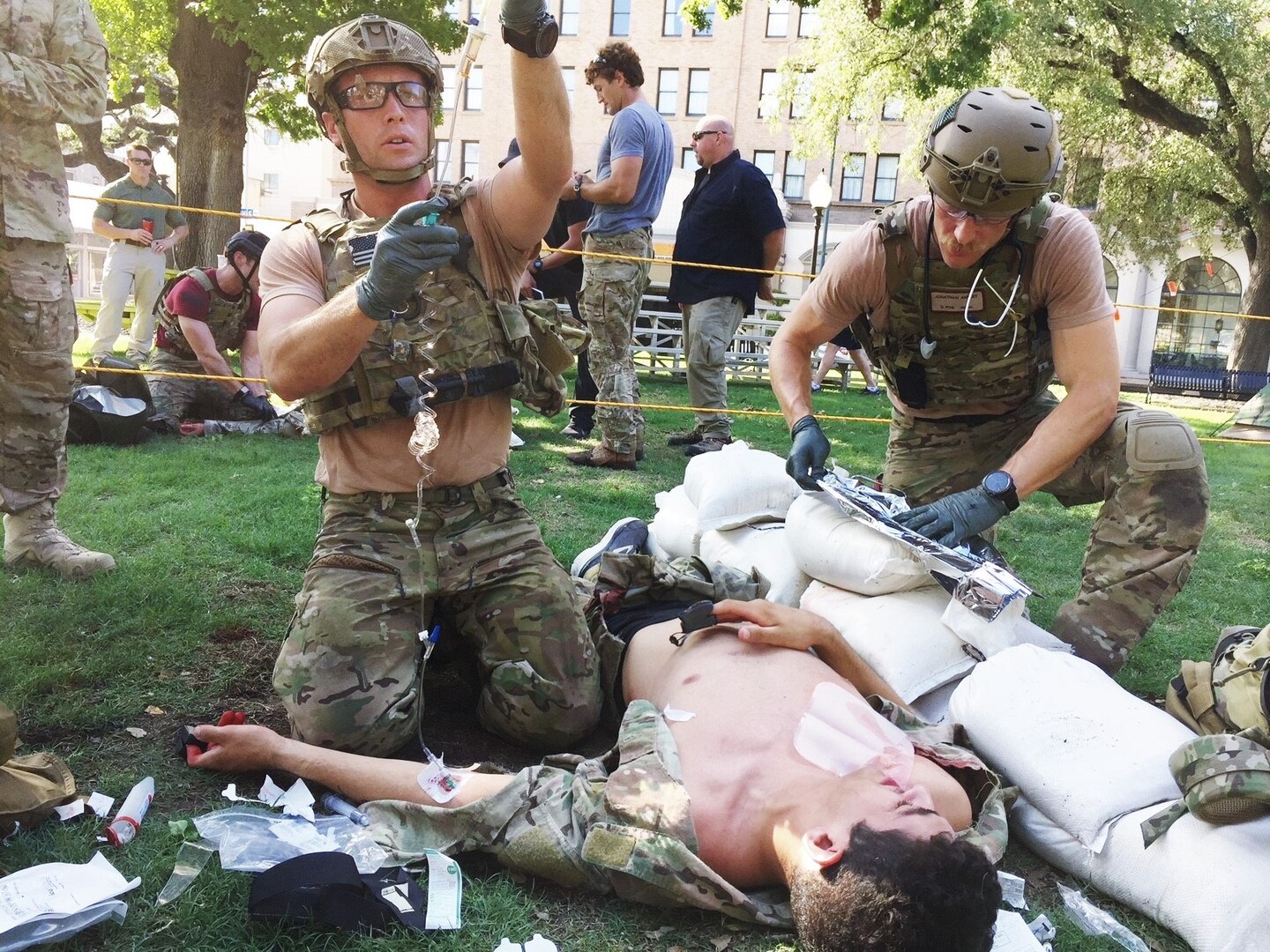 U.S. Air Force Pararescuemen, 304th Rescue Squadron Portland, Oregon, provide medical attention to Airman First Class James Pedrie, PJ Rodeo volunteer, for a simulated gunshot wound at the PJ Rodeo in San Antonio, Texas, Sept. 19, 2018. The PJ Rodeo provides comradery, networking opportunities, and serves as a source of additional training for competitors.