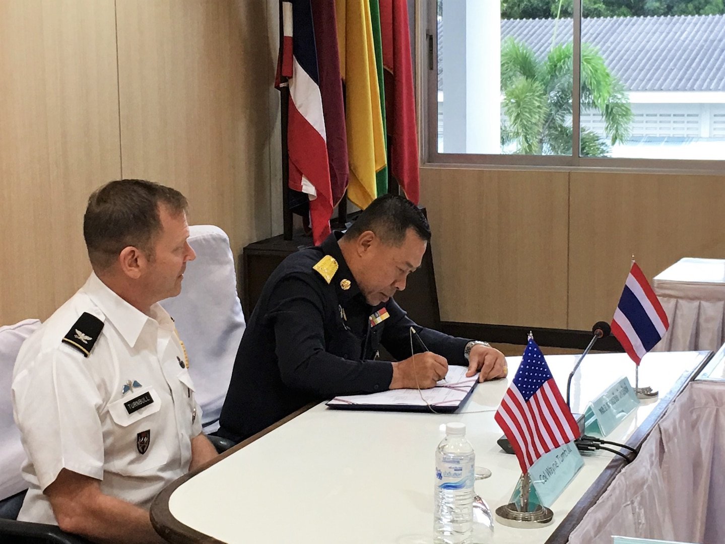 Royal Thailand Air Force Air Marshal Yuttachai Watcharasing (right) signs an agreement for space situational awareness services and data as U.S. Army Col. Wayne Turnbull, senior defense official and defense attaché to Thailand, witnesses the signing, Oct. 1, 2018, in Thailand. Agreements like these bolsters the United States and Thailand’s awareness in the space domain. (Courtesy Photo)