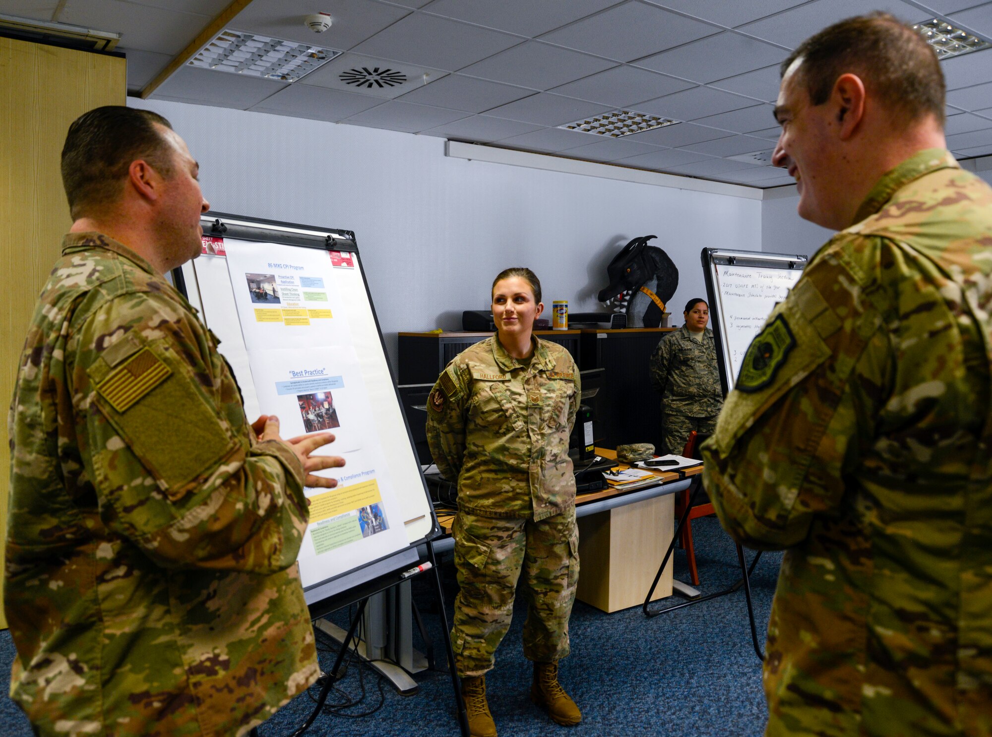 U.S. Air Force Brig. Gen. Mark R. August, 86th Airlift Wing commander, listens to a brief given by 86th Maintenance Group Airmen on Ramstein Air Base, Germany, Oct. 9, 2018. During the brief, August and Chief Master Sgt. Ernesto J. Rendon Jr., 86th AW command chief, learned about many of the training and continuous process improvement initiatives the 86th MXG has in place, some of which have been designated as processes other units around the Air Force should implement. (U.S. Air Force photo by Staff Sgt. Timothy Moore)