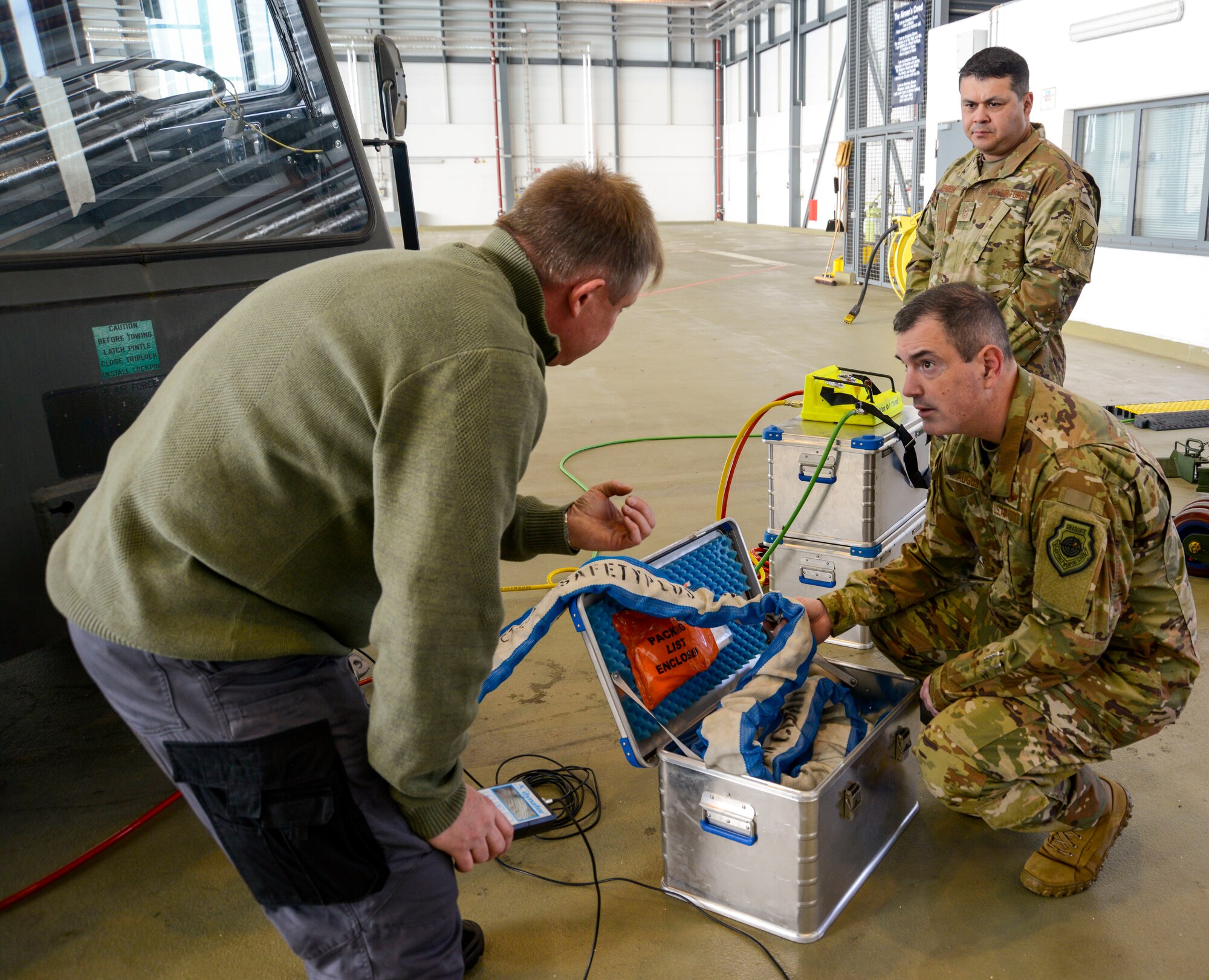 U.S. Air Force Brig. Gen. Mark R. August, 86th Airlift Wing commander, and Chief Master Sgt. Ernesto J. Rendon Jr., 86th AW command chief, test some of the new tools the 86th Maintenance Squadron uses during an immersion tour of the 86th Maintenance Group on Ramstein Air Base, Germany, Oct. 9, 2018. The command team learned that many of the new tools not only make the job easier but also make it safer for Airmen. (U.S. Air Force photo by Staff Sgt. Timothy Moore)