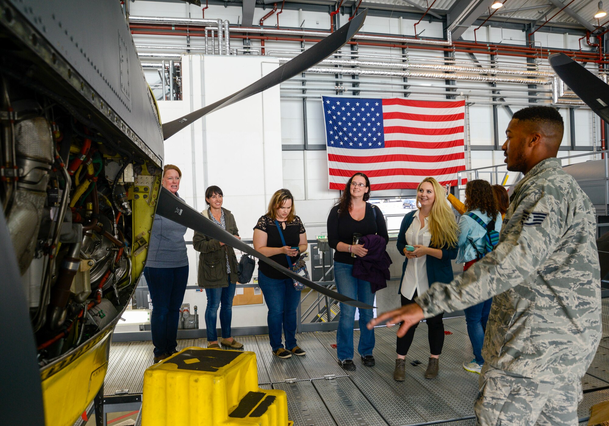 86th Airlift Wing key spouses receive a briefing about the types of maintenance checks the 86th Maintenance Squadron performs during an immersion tour of the 86th Maintenance Group on Ramstein Air Base, Germany, Oct. 9, 2018. The spouses got to see a C-check, which is an extensive maintenance check that can require the removal of the aircraft’s engines. (U.S. Air Force photo by Staff Sgt. Timothy Moore)