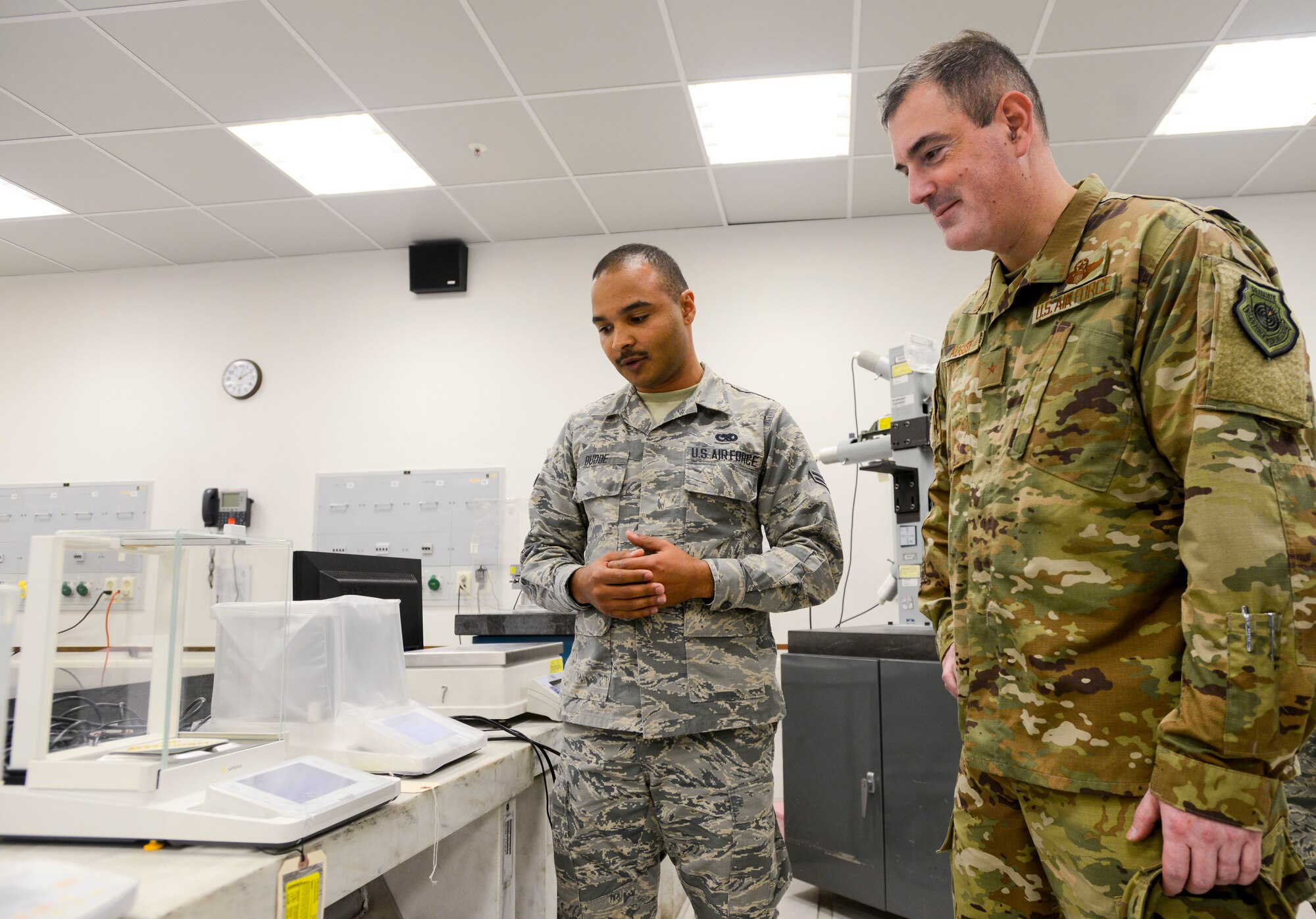 U.S. Air Force Brig. Gen. Mark R. August, 86th Airlift Wing commander, waits to see the literal weight of his signature during an immersion tour of the 86th Maintenance Group on Ramstein Air Base, Germany, Oct. 9, 2018. The 86th Maintenance Squadron Precision Measurement Equipment Laboratory Flight, which is the largest of the three PMEL flights in U.S. Air Forces in Europe, supports four combatant commands by calibrating equipment that requires quantitative measurements, some even as small as the weight difference a signature makes on a coaster. (U.S. Air Force photo by Staff Sgt. Timothy Moore)