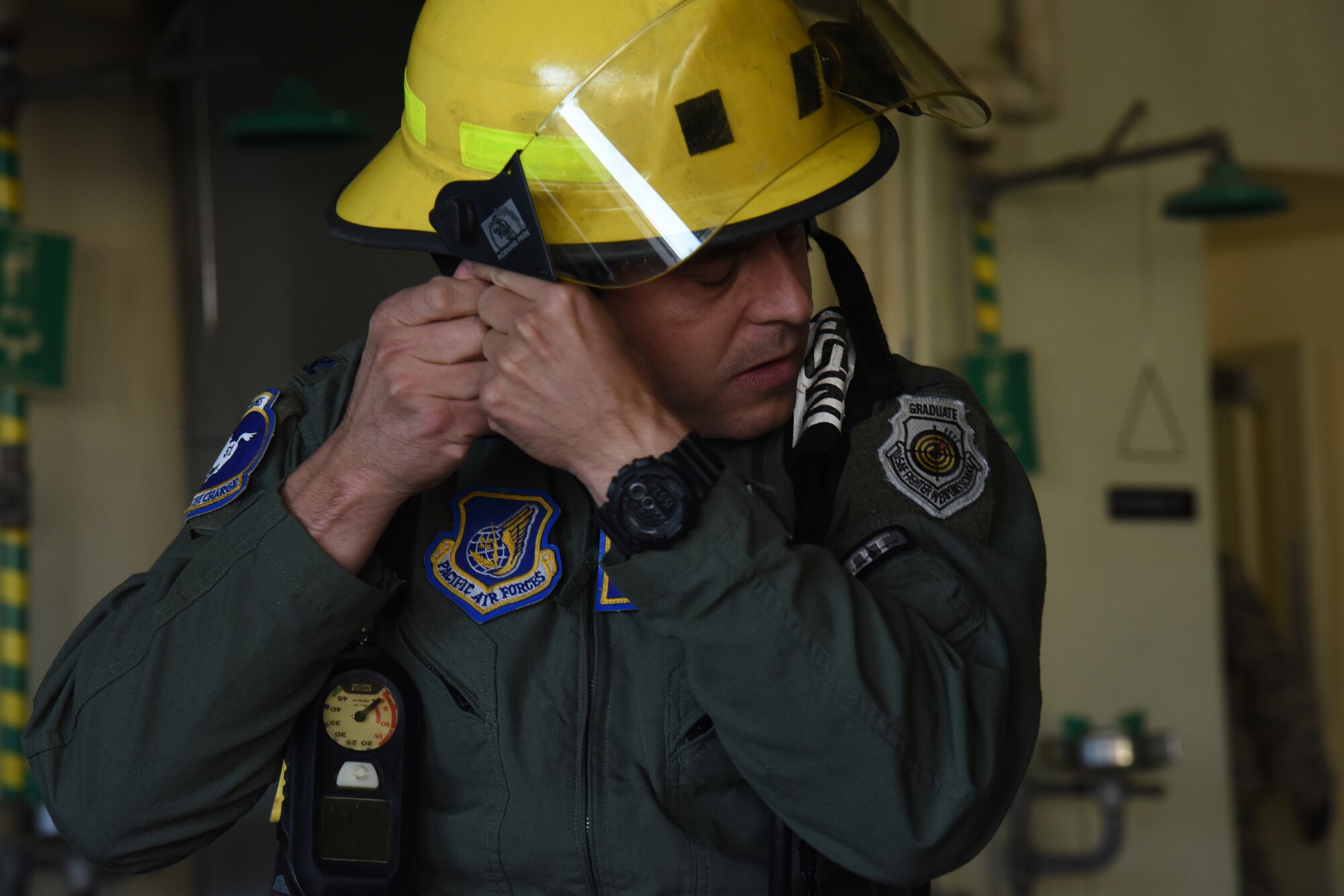 U.S. Air Force Col. Jesse Friedel, 51st Fighter Wing vice commander, puts on a helmet during the Eagles and Commanders versus Chiefs and Shirts Fire Muster at Osan Air Base, Republic of Korea, Oct. 12, 2018. The event was a relay where individuals, then teams, competed for the best time. (U.S. Air Force photo by Tech. Sgt. Ashley Tyler)