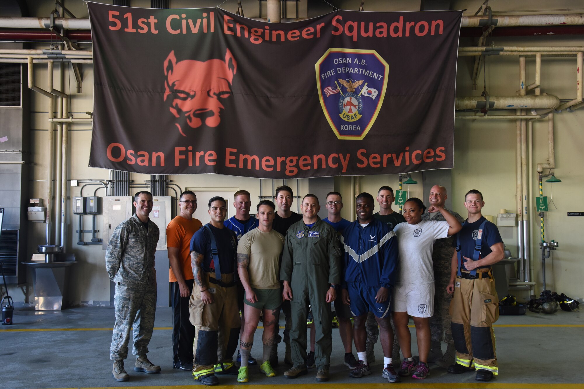Participants pose for a group photo after completing the Eagles and Commanders versus Chiefs and Shirts Fire Muster at Osan Air Base, Republic of Korea, Oct. 12, 2018. The event, held during Fire Prevention Week 9 through 13 Oct., was a friendly competition between higher officer and enlisted leaders who competed individually, then as teams, through six stations such as ladder climbing and fire hose pulling for the best time. (U.S. Air Force photo by Tech. Sgt. Ashley Tyler)