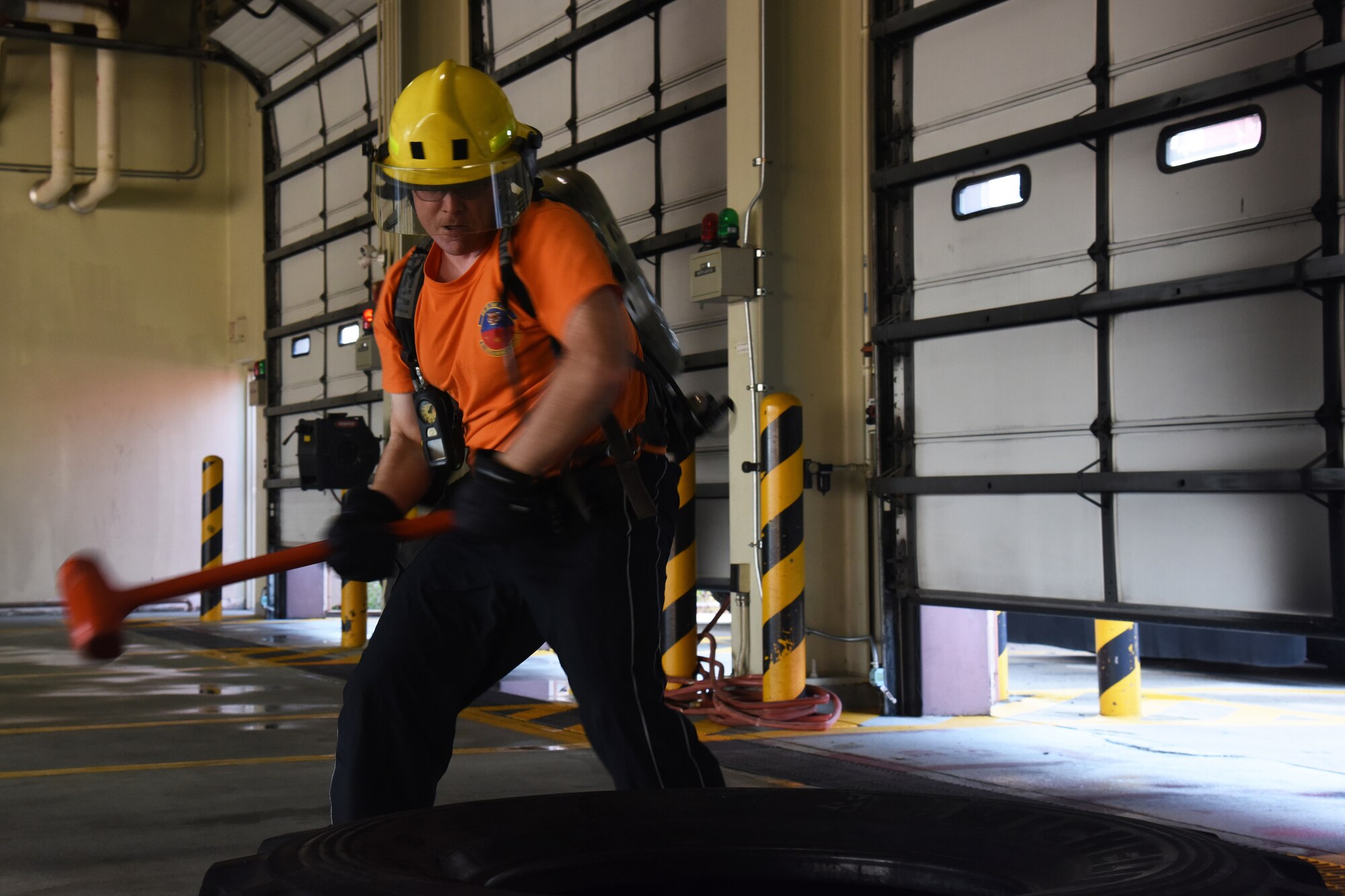 U.S. Air Force Chief Master Sgt. David Plouff, 6th Intelligence Squadron superintendent, hammers a vehicle tire during the Eagles and Commanders versus Chiefs and Shirts Fire Muster at Osan Air Base, Republic of Korea, Oct. 12, 2018. The fire muster was a competition between higher officer and enlisted personnel to help raise awareness during Fire Prevention Week, wich was held 9 through 13 Oct. (U.S. Air Force photo by Tech. Sgt. Ashley Tyler)