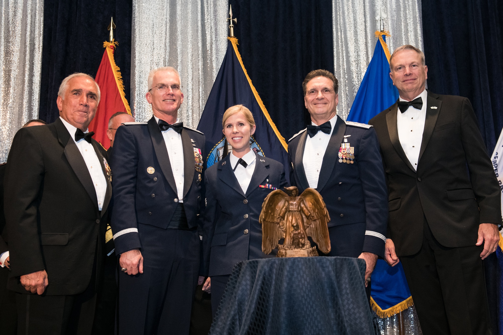 U.S. Air Force Senior Airman Linda M. Wilson (center) receives the Angel of the Battlefield award presented by Retired U.S. Army Gen. John Tilelli, Chairman of the Armed Services YMCA (far left), U.S. Air Force Gen. Paul J. Selva, Vice Chairman of the Joint Chiefs of Staff (second from left), U.S. Air Force Maj. Gen. (Dr.) Sean L. Murphy, Deputy Surgeon General of the U.S. Air Force (second from right), and Retired U.S. Navy Vice Adm. William D. French, President and Chief Executive Officer of the ASYMCA (far right), during the 2018 Armed Services YMCA Angels of the Battlefield Awards Gala in Arlington, Virginia, Oct. 2, 2018. Wilson risked her own life to save others during the deadly mass shooting at the Route 91 Harvest Festival in Las Vegas, Nevada on Oct. 1, 2017. Wilson flagged down numerous cars to transport wounded victims, obtained first-aid supplies to treat victims, directed the use of clothing for improvised tourniquets, and loaded eight critically injured victims into a car, providing lifesaving treatment en route to the hospital. (DoD photo by U.S. Army Sgt. James K. McCann)