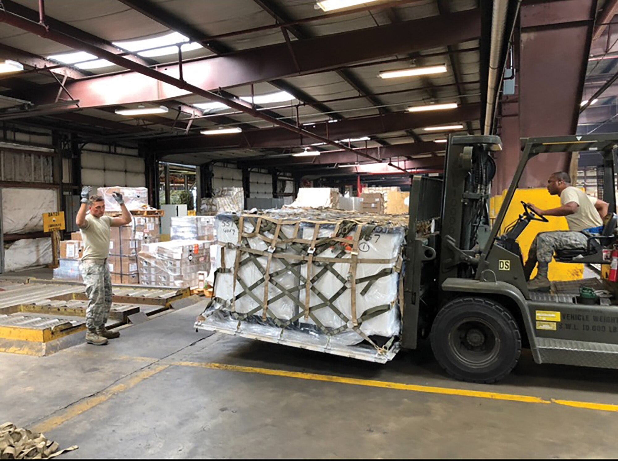 87th Aerial Port Squadron Airmen move a pallet during their annual tour while participating in Patriot Partner exercise with their Naval counterparts at Norfolk Naval Air Station's Navy Operated Air Mobility Command Terminal July 6-20, 2018.