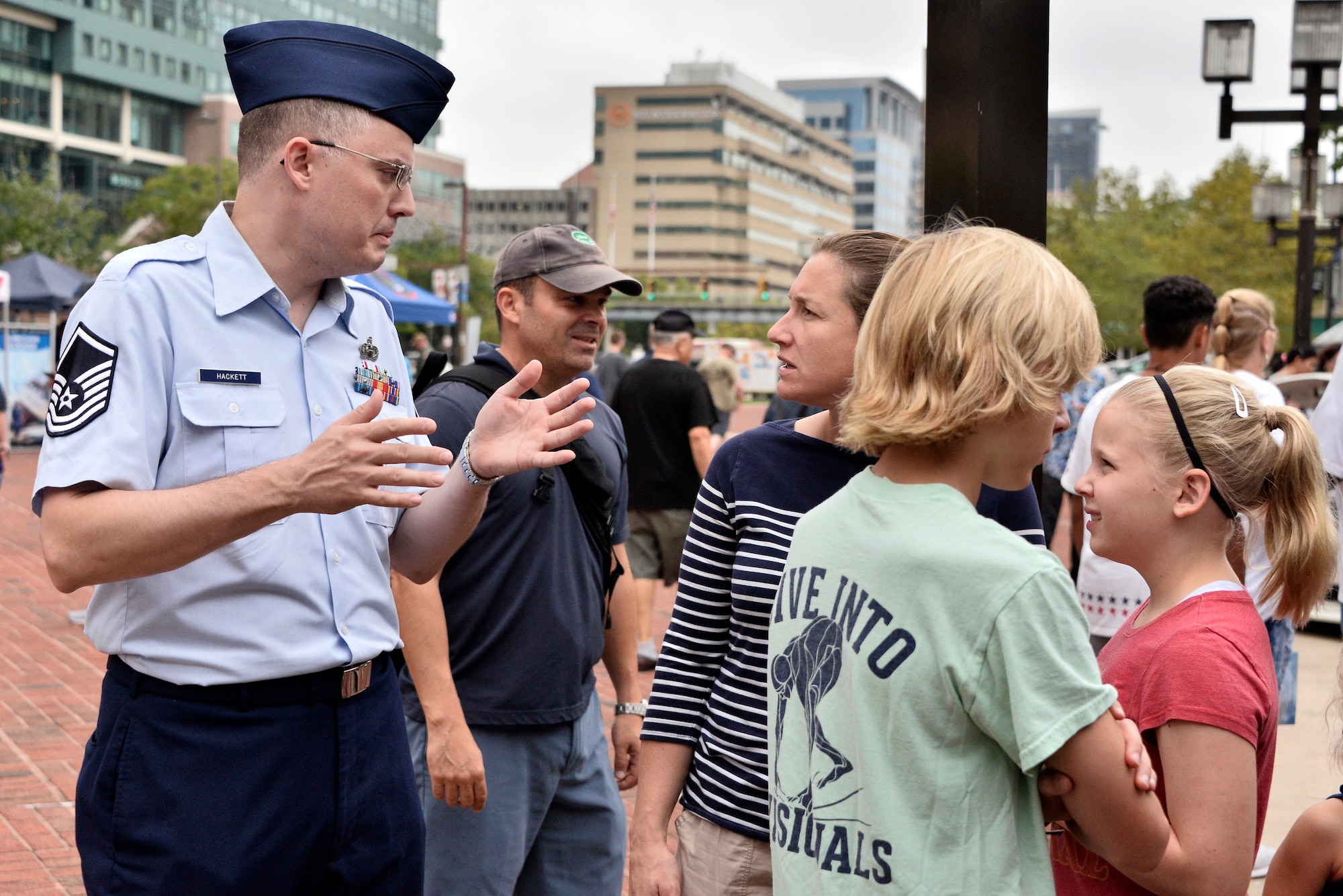 Master Sgt. Marshall Hackett, 70th Operations Support Squadron chief military language instructor, explains his career field to local residents and Air Force opportunities during Fleet Week October 6, 2018 in Baltimore, Maryland. Fleet Week Baltimore gave Maryland residents a chance to meet and learn about U.S. maritime capabilities of the U.S. Navy and Marine Corps, along with promoting community growth and interaction with all services. (U.S. Air Force photo by Staff Sgt. Alexandre Montes)