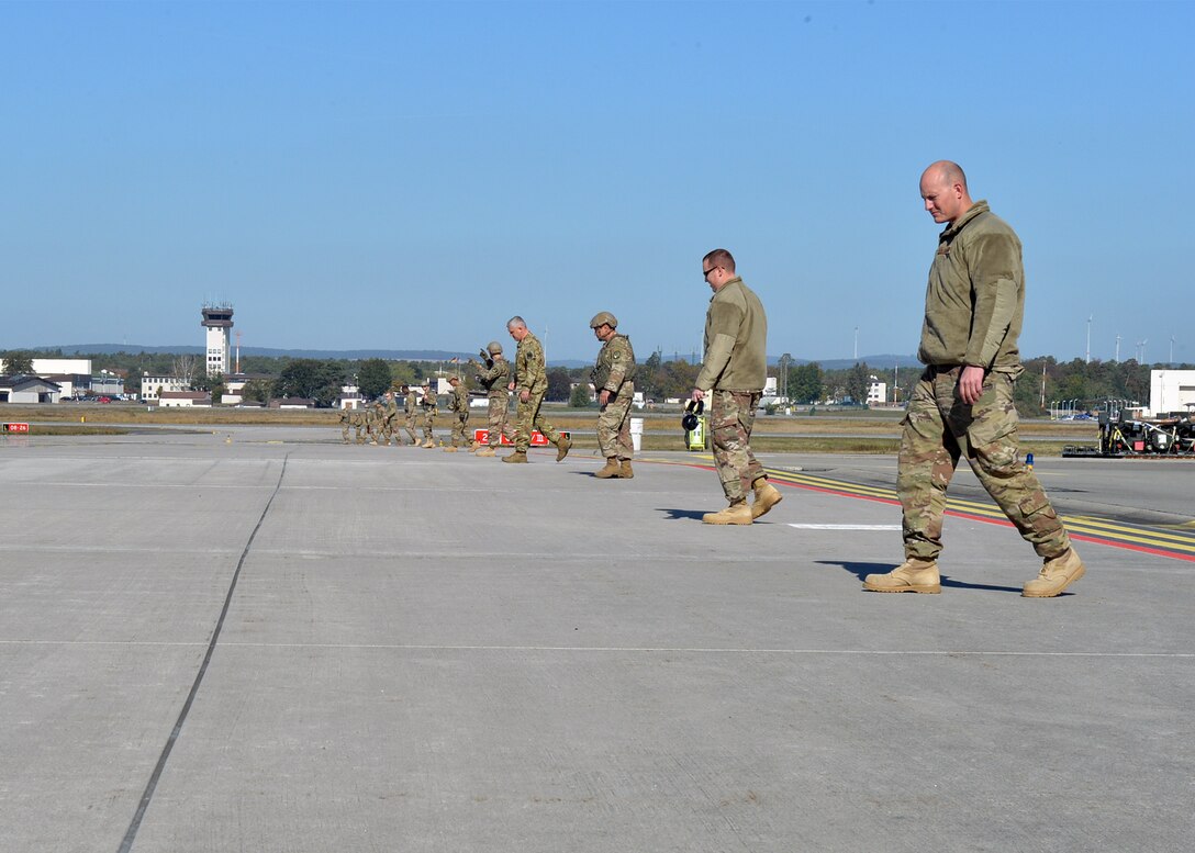 Airmen assigned to the 435th Contingency Response Group conduct a foreign object debris walk on Ramstein Air Base, Germany, Oct. 4, 2018. The FOD walk was done to prevent any debris from causing damage to aircraft during exercise Temperate Ace. (U.S. Air Force photo by Staff Sgt. Jimmie D. Pike)