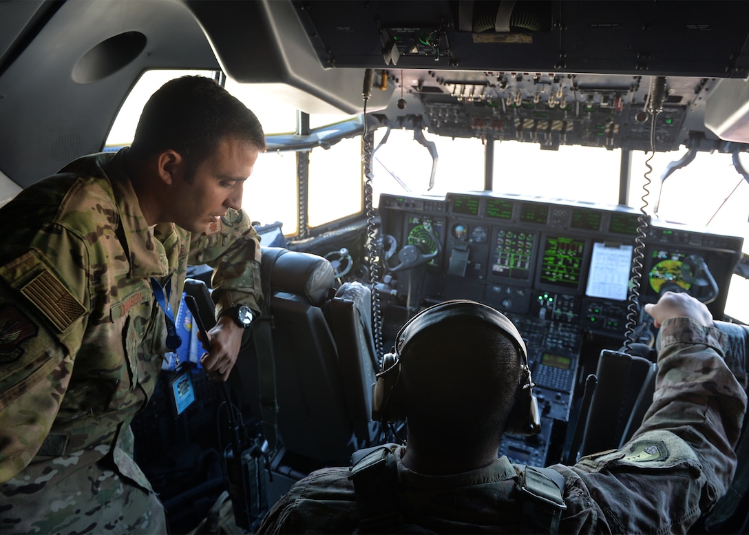U.S. Air Force Maj. Christopher Thomsen, 435th Contingency Response Squadron director of operations, and Senior Airman Andrew Domingo, 435th CRS C-130J Super Hercules crew chief, monitor gauges as a C-130J is de-fueled on Ramstein Air Base, Germany. As part of an exercise, members of the 435th Contingency Response Group defueled a C-130J and performed a “hot refuel” on two F-16 Fighting Falcon aircraft. (U.S. Air Force photo by Staff Sgt. Jimmie D. Pike)