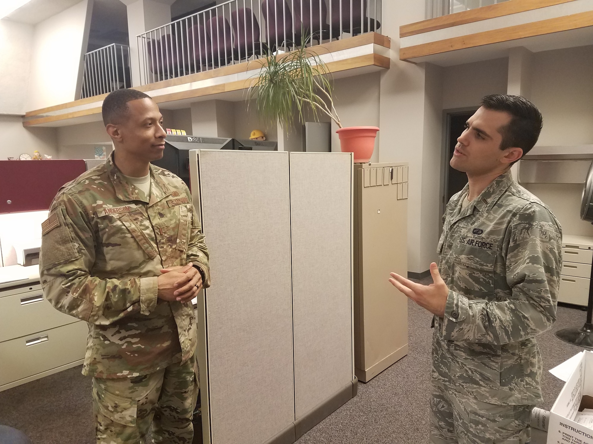 2nd Lt. Evan Ewing (right), contracting specialist with the Air Force Life Cycle Management Center's Installation Contracting Division, discusses policy with 2nd. Lt. Thomas Anderson, also a contracting specialist with the division.