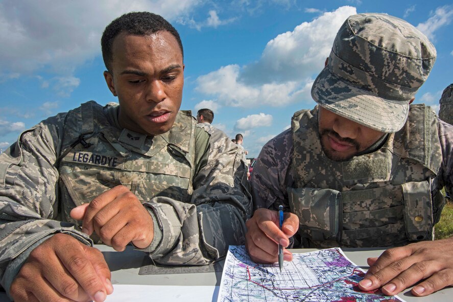 Senior Airmen Aaron Legardye, left, and Anthony Poindexter, 11th Security Forces Squadron response force members, participate in a land navigation exercise during the 11th SFS Defender’s Challenge on Joint Base Andrews, Md., Oct. 3, 2018. The challenge tested the defenders’ physically, as well as, mentally, in weapons knowledge, urban tactics, land navigation, self-aid buddy care and response to attacks. (U.S. Air Force photo by Airman 1st Class Michael S. Murphy)