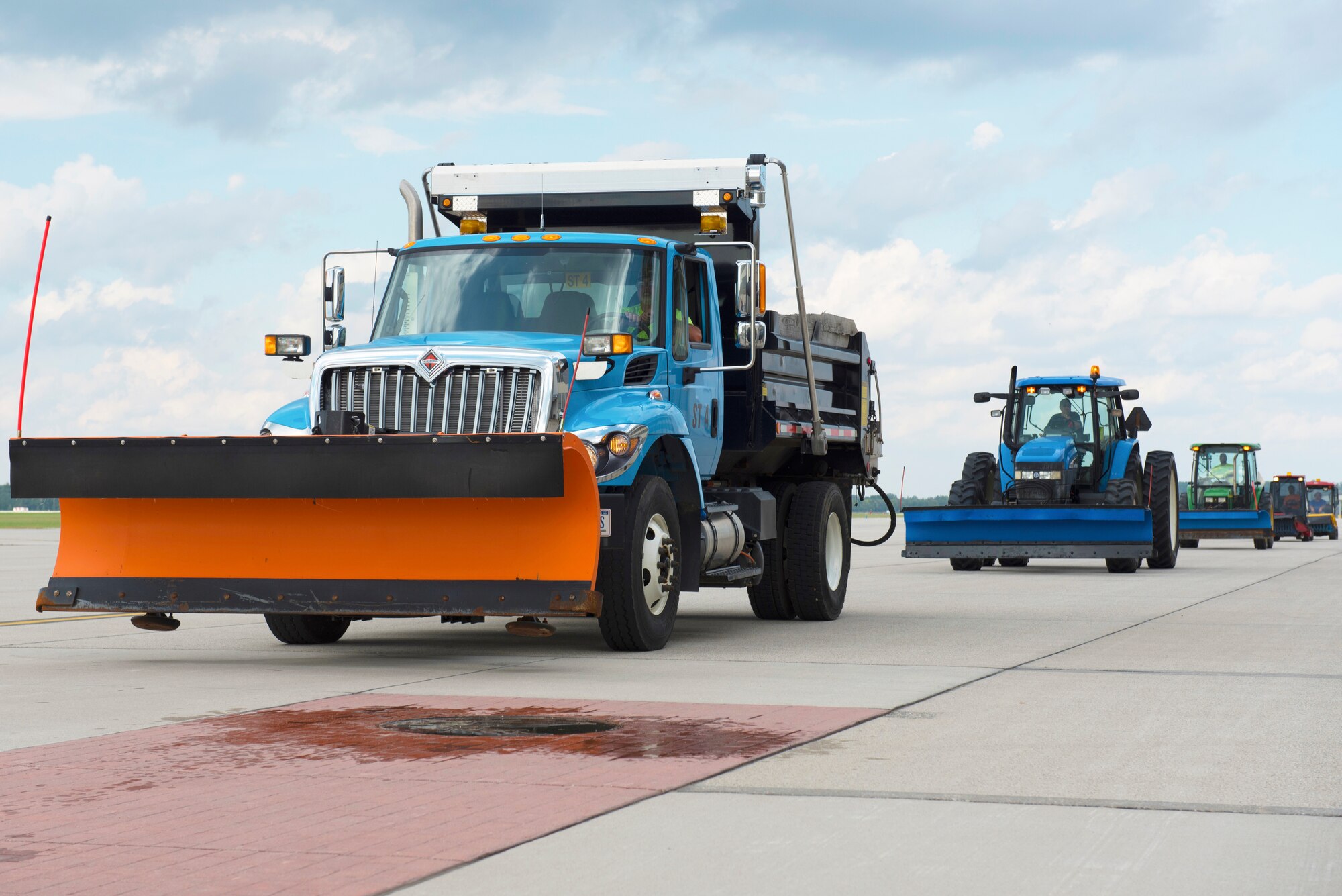 The 88th Civil Engineering Group heavy equipment and grounds crew, drive along the flightline during the annual snow truck and ice parade at Wright-Patterson Air Force Base, Ohio, October 3, 2018.