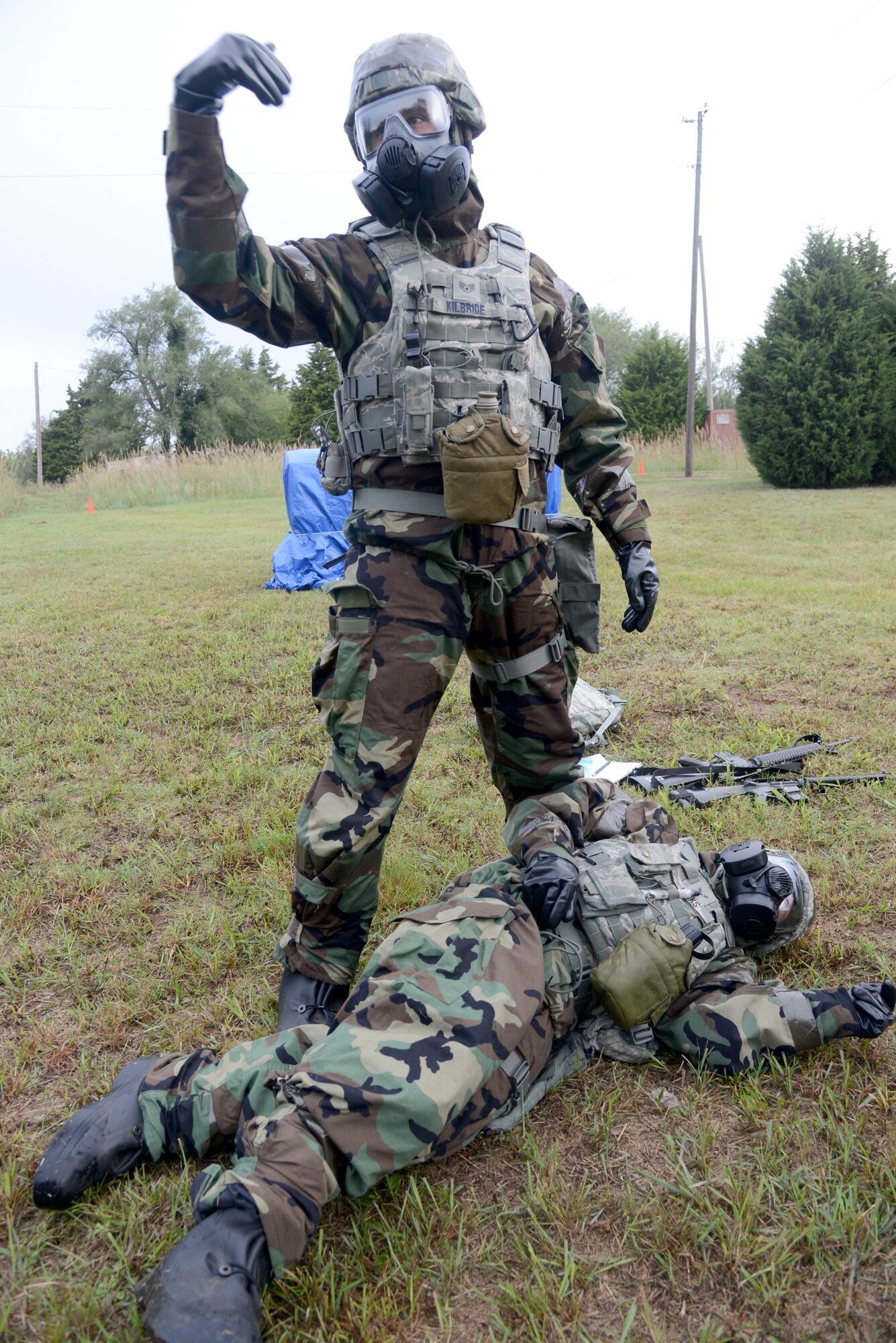 Staff Sgt. James Kilbride, 72nd Security Forces Squadron, motions for help after a member of his team was exposed to chemical agents from a tear in his gear during the chemical, biological, radiological, nuclear, explosives exercise Sept. 28. (U.S. Air Force photos/Kelly White)