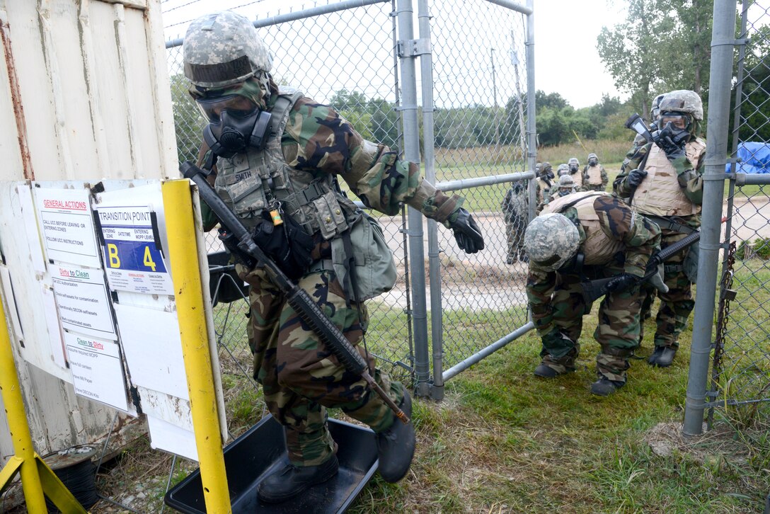 Participants in the CBRNE exercise simulate going through a decontamination area by scrubbing the outside of their Mission-Oriented Protective Posture 4 gear and thoroughly washing their feet while going from one zone into another. The reasoning for this is that one zone may be contaminated and the one they are entering is not, so going through a thorough decontamination process is vital to preventing contamination.