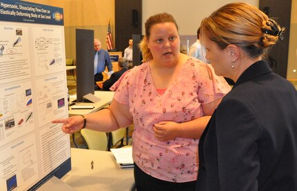 IMAGE: KING GEORGE, Va. (Sept. 25, 2018) – Principal investigator Erika Lieberknecht briefs Naval Surface Warfare Center Dahlgren Division (NSWCDD) Chief Technology Officer Kate Jones at the NSWCDD In-house Laboratory Independent Research (ILIR) and Independent Applied Research (IAR) End of Year Review. Lieberknecht -- an NSWCDD aerospace engineer engaged in a Ph.D. program focusing on hypersonic fluid-thermal-structure interaction under sea-level conditions -- identified challenges, objectives, accomplishments and future benefits related to her ILIR project, "Hypersonic, Dissociating Flow Over an Elastically Deforming Body at Sea Level".