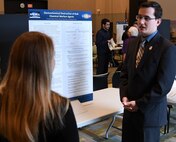 IMAGE: KING GEORGE, Va. (Sept. 25, 2018) – Principal investigator Michael Parsons briefs a visitor at the Naval Surface Warfare Center Dahlgren Division (NSWCDD) In-house Laboratory Independent Research (ILIR) and Independent Applied Research (IAR) End of Year Review at the University of Mary Washington Dahlgren Campus. Parsons -- an NSWCDD scientist who graduated this year from the Virginia Military Institute -- explained his ILIR project, “Electrochemical Destruction of Bulk Chemical Warfare Agents” to Navy technical managers, engineers, and scientists as well as representatives from academia, industry, transition partners, and other key stakeholders. Funded by the Office of Naval Research, the ILIR and IAR program fosters fundamental and applied research at the Navy Warfare Centers to counter emerging threats by connecting technological needs with current and emerging capabilities.