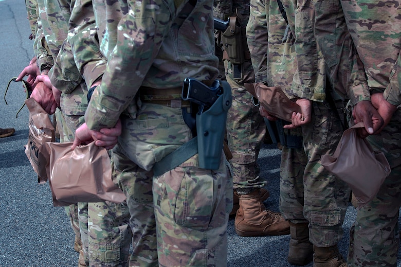 Defenders from the 822d Base Defense Squadron hold meals, ready to eat (MREs) in formation prior to departing Moody Air Force Base, Ga., to provide base security at Tyndall AFB, Fla., during Hurricane Michael recovery efforts, Oct. 11, 2018. Moody’s ‘Safeside’ defenders will secure the area as Tyndall’s Ride Out Element conducts damage assessments during the aftermath. Since Oct. 8 and until further notice, Tyndall has been on evacuation notice. (U.S. Air Force photo by Senior Airman Greg Nash)