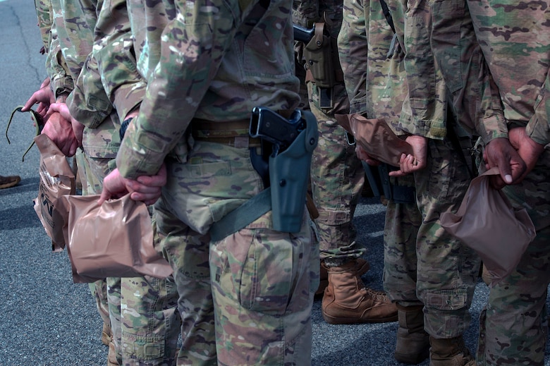 Defenders from the 822d Base Defense Squadron hold meals, ready to eat (MREs) in formation prior to departing Moody Air Force Base, Ga., to provide base security at Tyndall AFB, Fla., during Hurricane Michael recovery efforts, Oct. 11, 2018. Moody’s ‘Safeside’ defenders will secure the area as Tyndall’s Ride Out Element conducts damage assessments during the aftermath. Since Oct. 8 and until further notice, Tyndall has been on evacuation notice. (U.S. Air Force photo by Senior Airman Greg Nash)