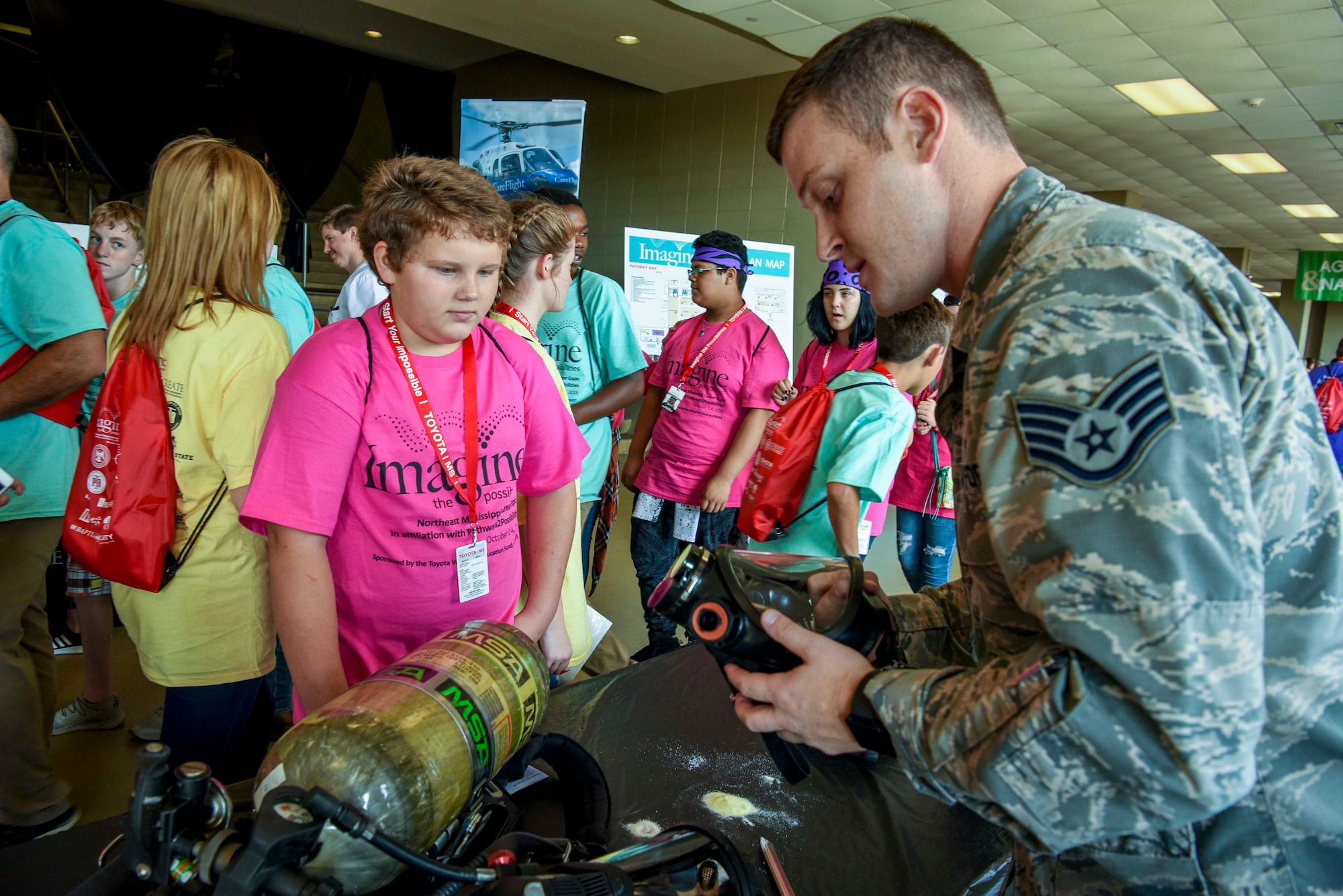 Staff Sgt. Bryce Cook, 14th Medical Operations Squadron’s Bioenvironmental Engineering NCO in charge of industrial hygiene, shows a gas mask to a student, Oct. 2, 2018, during the Imagine the Possibilities Career Expo at the BancorpSouth Arena in Tupelo, Mississippi. More than 120 Airmen from Columbus AFB, Mississippi, spent several days showing more than 7,000 eighth-grade students, from northeast Mississippi counties, some of the vast career opportunities the Air Force offers. (U.S. Air Force photo by Tech. Sgt. Christopher Gross)