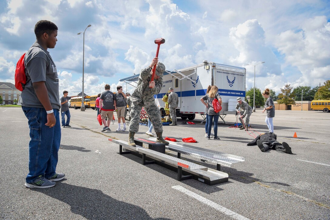Senior Airman Dylan Brown, Columbus Air Force Base Fire Department driver and operator, demonstrates a hammer swing on a Keiser FORCE Machine Oct. 2, 2018, during the Imagine the Possibilities Career Expo at the BancorpSouth Arena in Tupelo, Mississippi. More than 120 Airmen from Columbus AFB, Mississippi, spent several days showing more than 7,000 eighth-grade students, from northeast Mississippi counties, some of the vast career opportunities the Air Force offers. (U.S. Air Force photo by Tech. Sgt. Christopher Gross)