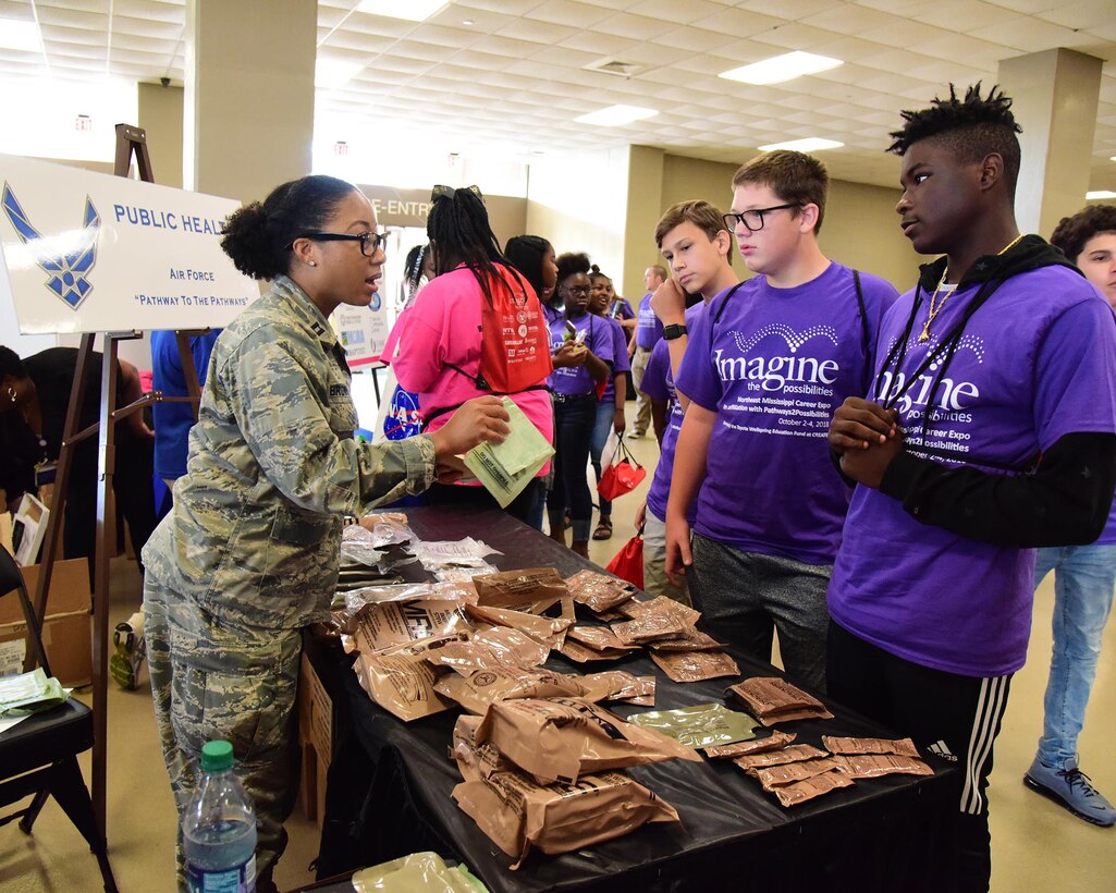 Capt. Amessia Brown, 14th Medical Operations Squadron Public Health Flight commander, shows students the content of meals ready to eat Oct. 2, 2018, during the Imagine the Possibilities Career Expo at the BancorpSouth Arena in Tupelo, Mississippi. Airmen from Columbus AFB represented seven of the 18 career pathways including aerospace, emergency management, engineering, government and public administration, health sciences, logistics as well as law and public safety. (U.S. Air Force photo by Elizabeth Owens)